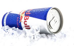 Swindon, United Kingdom - February 1, 2014: SWINDON, UK - FEBRUARY 1, 2014: Can of Red Bull Energy Drink on ice over a white background